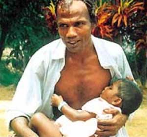 Man breastfeeding his baby